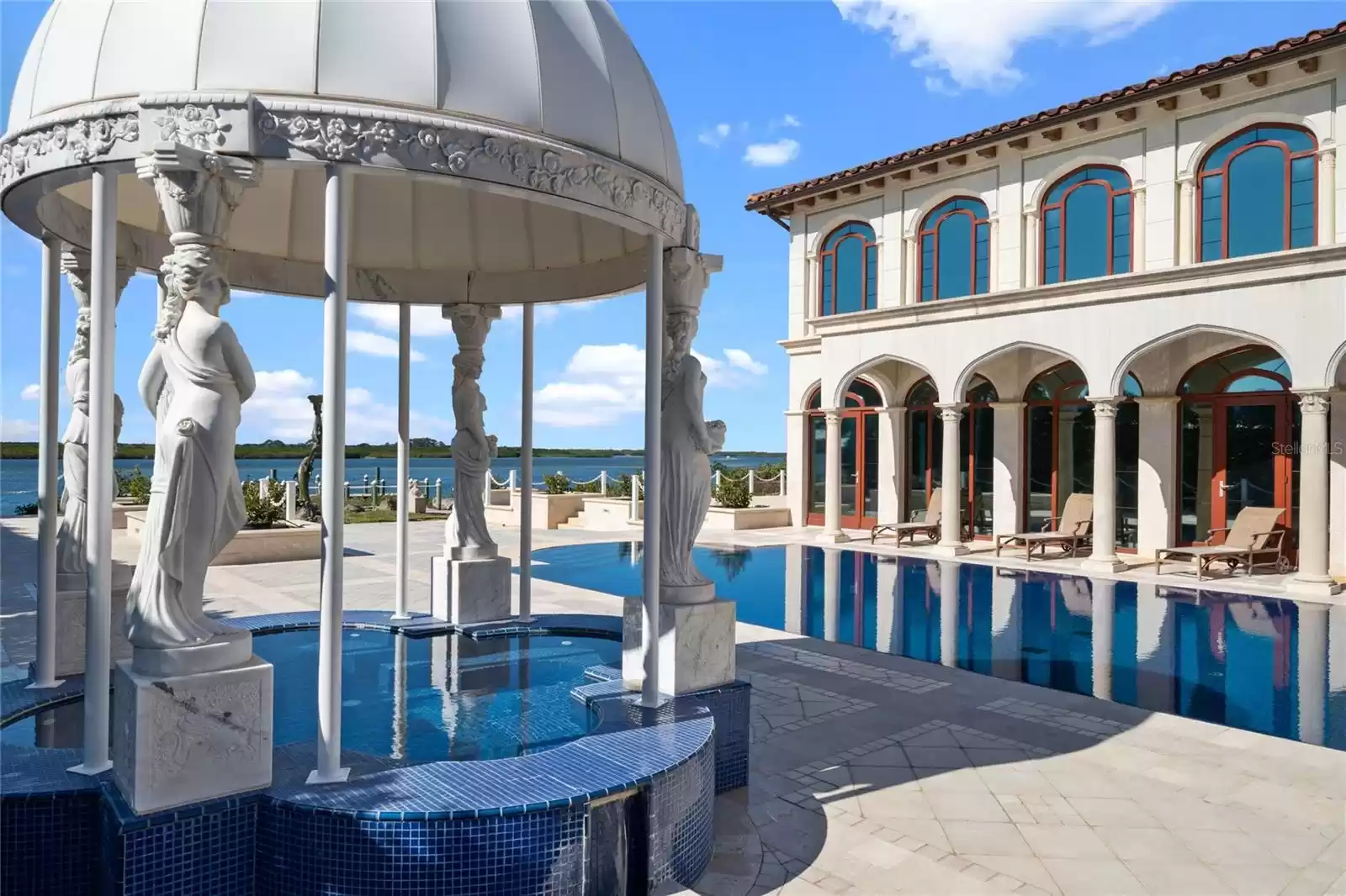 The spa is covered with with a custom designed Carrara marble pergola.