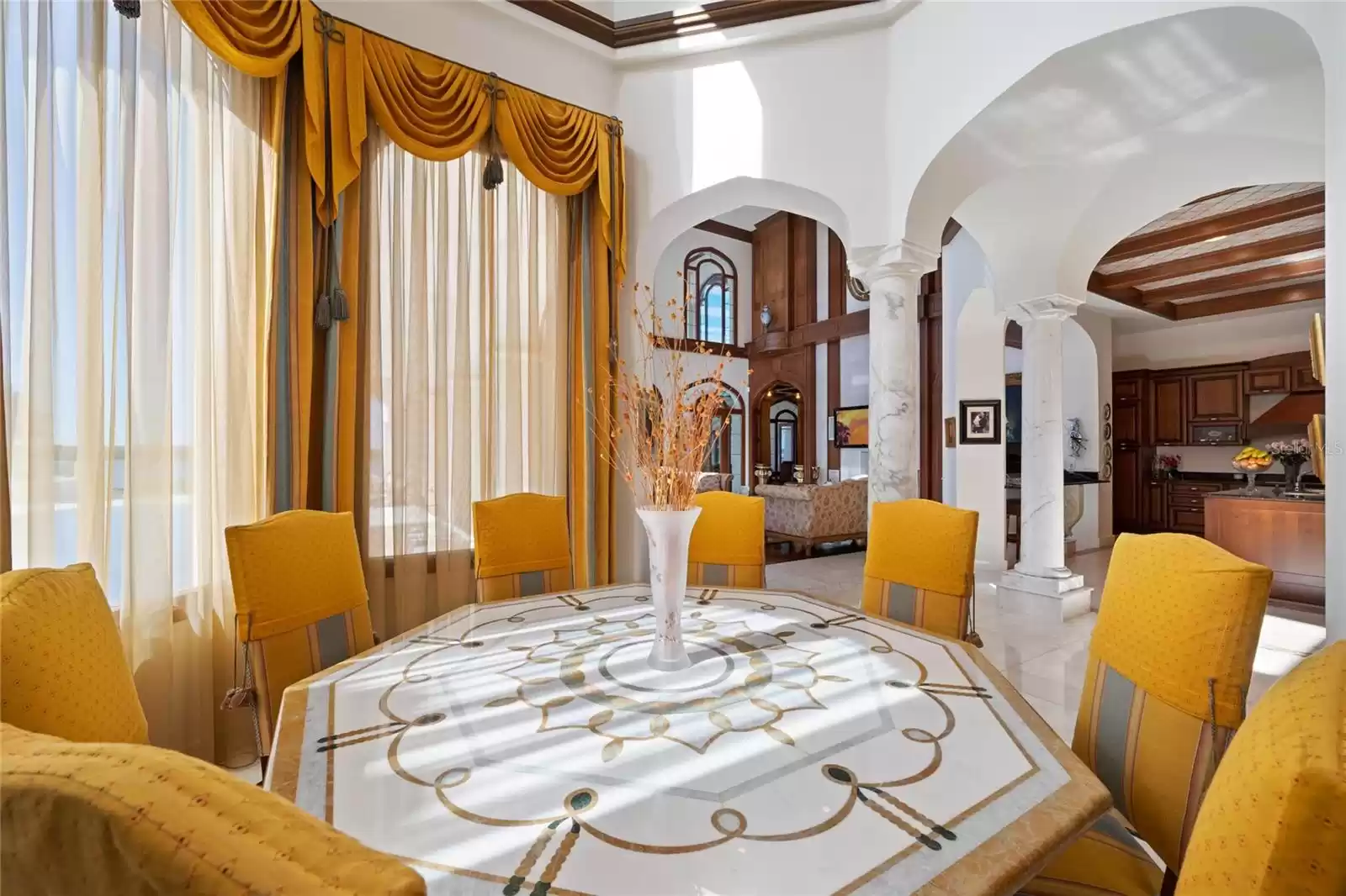 Marble table and floors in the breakfast room designed to accent the imported Italian crystal ceiling