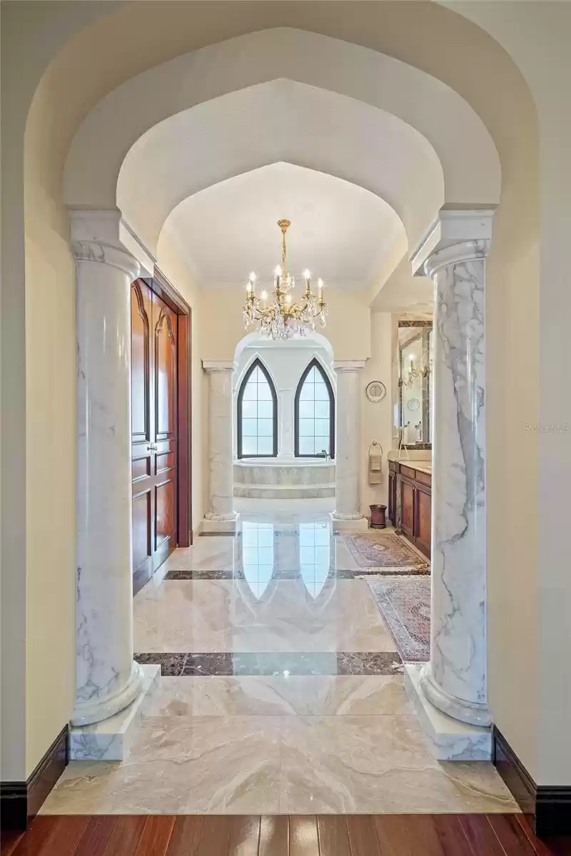 Marvel at the beauty of the open book marble flooring as the light reflects its wonders