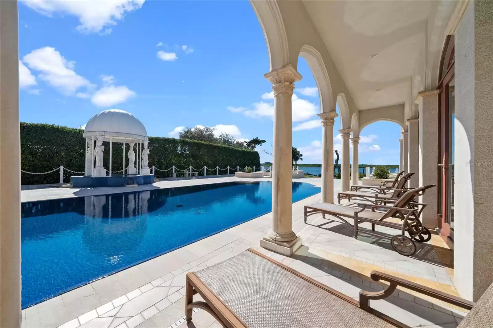 Step outside onto the veranda that leads to the luxurious floating edge pool and spa