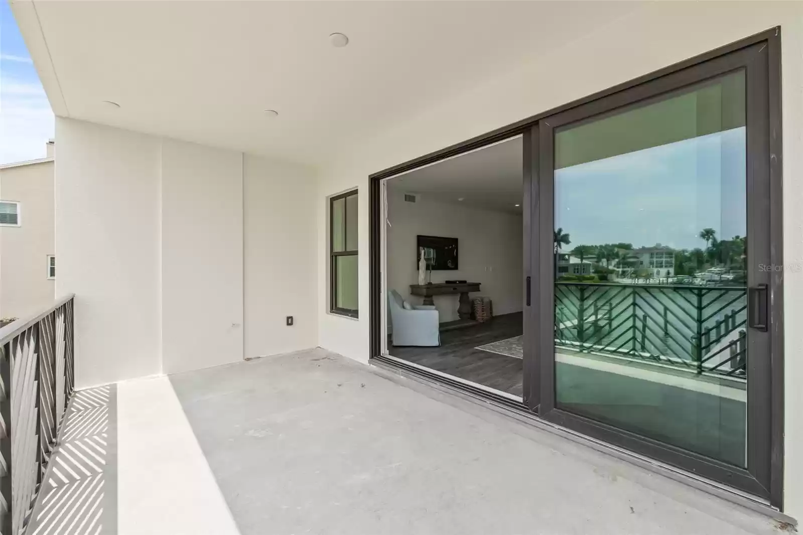 The large balcony includes recess lighting and a ceiling fan.