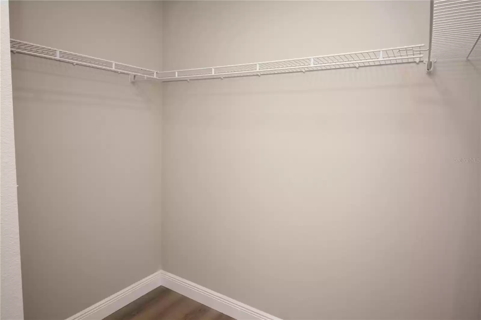 Primary bedroom walk-in closet