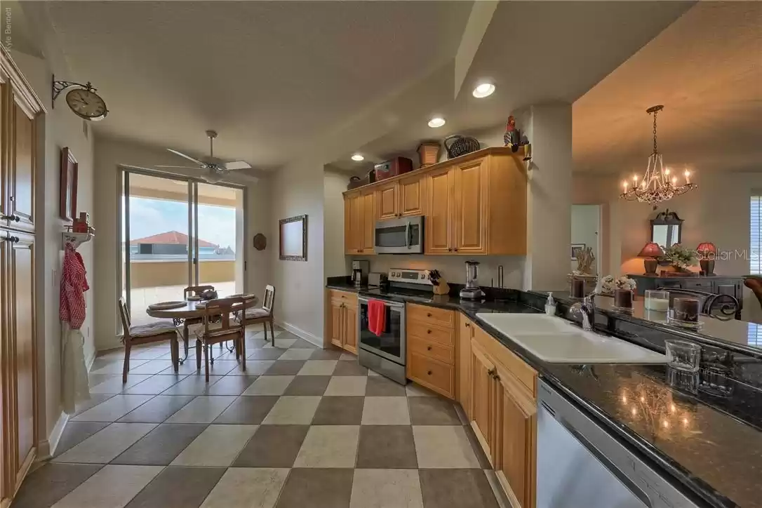 Kitchen with small eating area and the access to terrace/deck