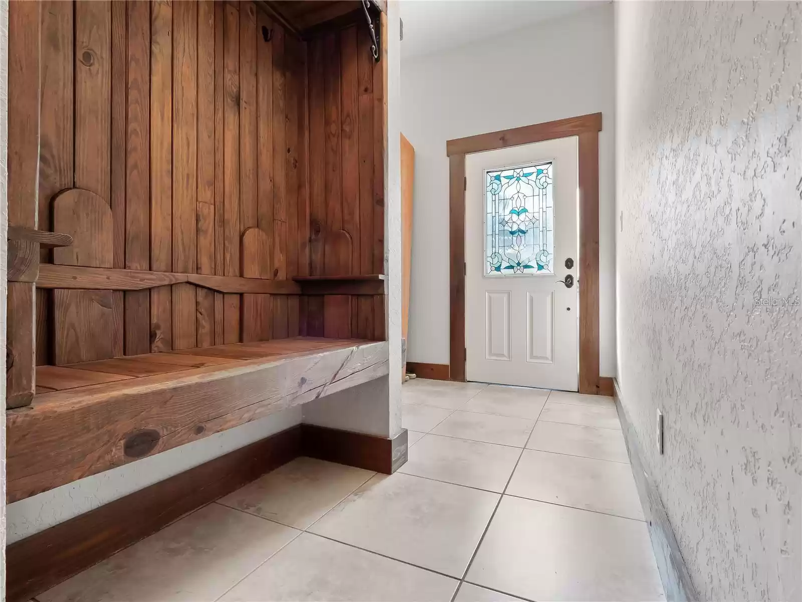 Mud room with adjoining laundry, leading to the garage and side entry door