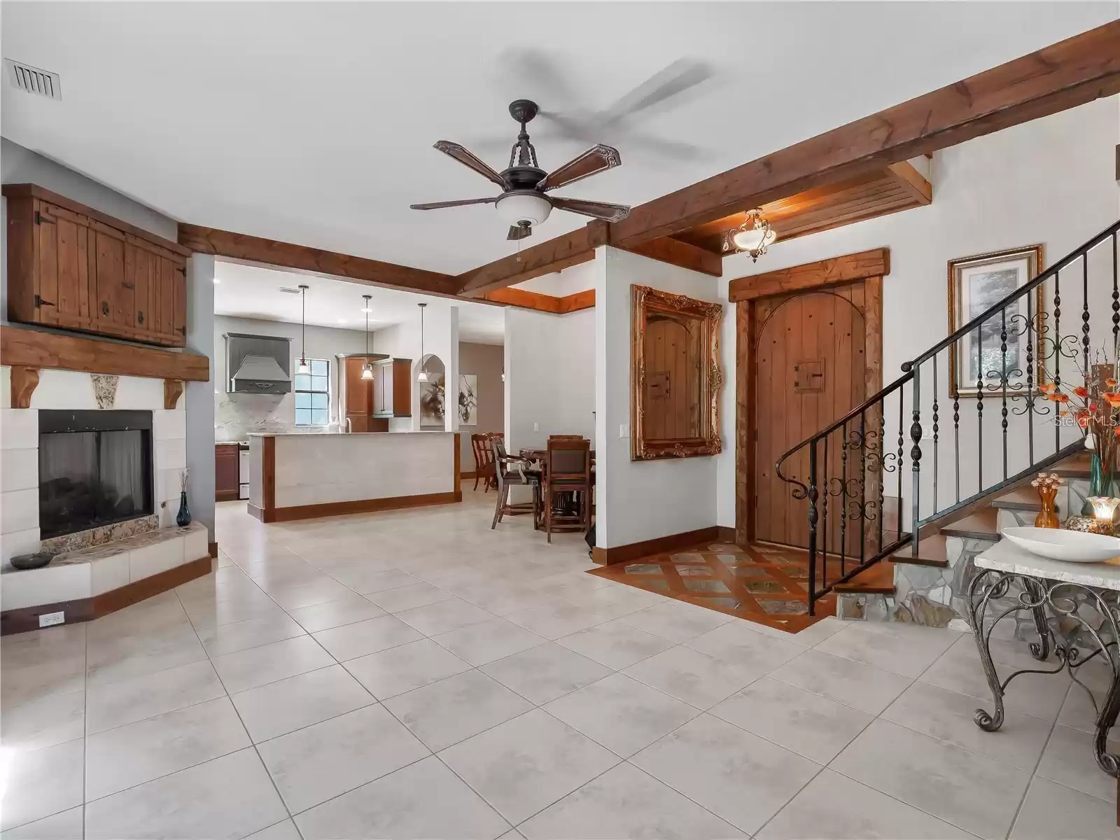 Living room with fireplace adjoins to kitchen, foyer, dinette, and dining room