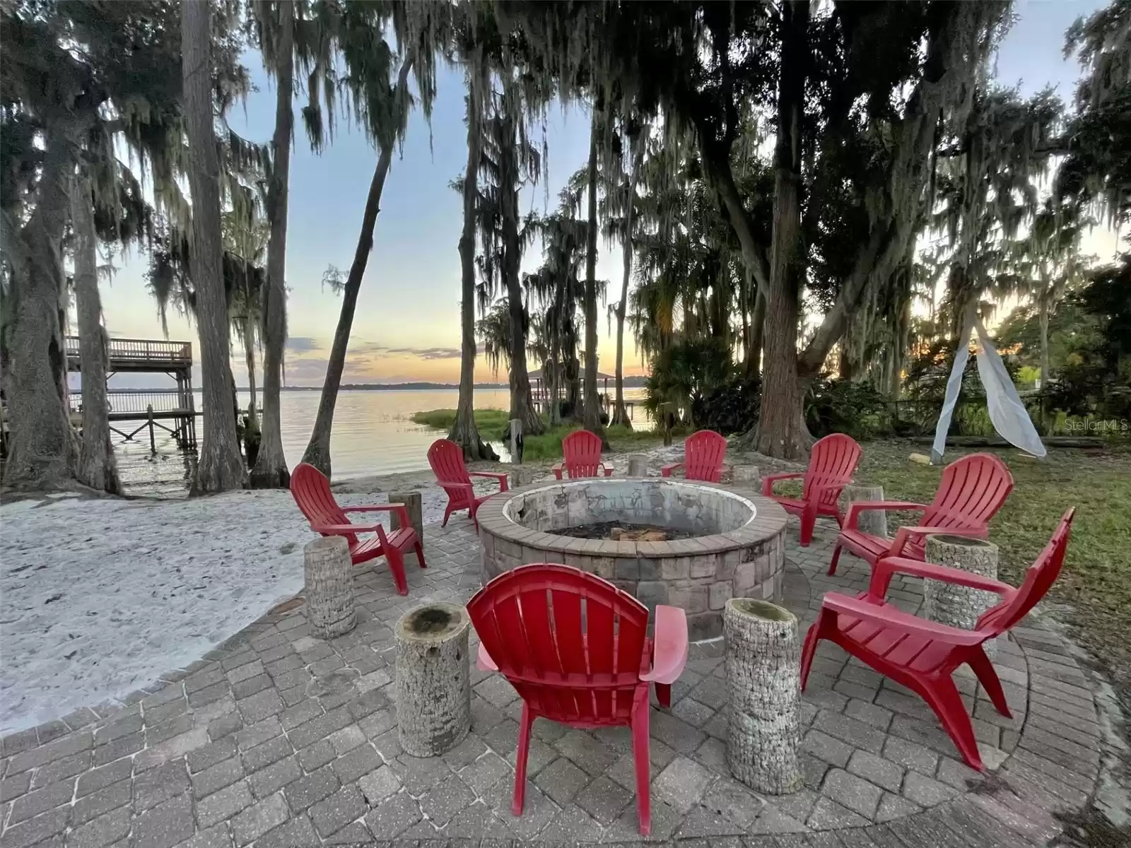 Large lake front brick paver fire pit area