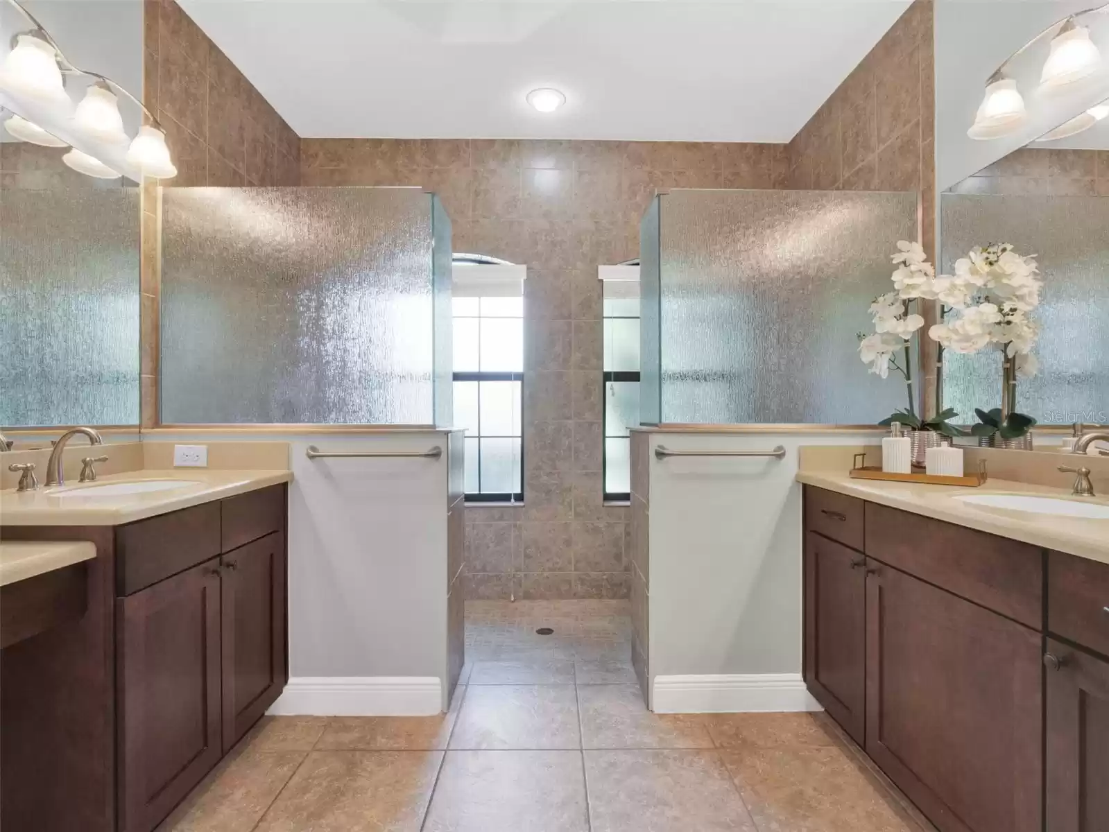 Primary bedroom with a double sink and a luxurious walk-in shower luxurious walk in shower