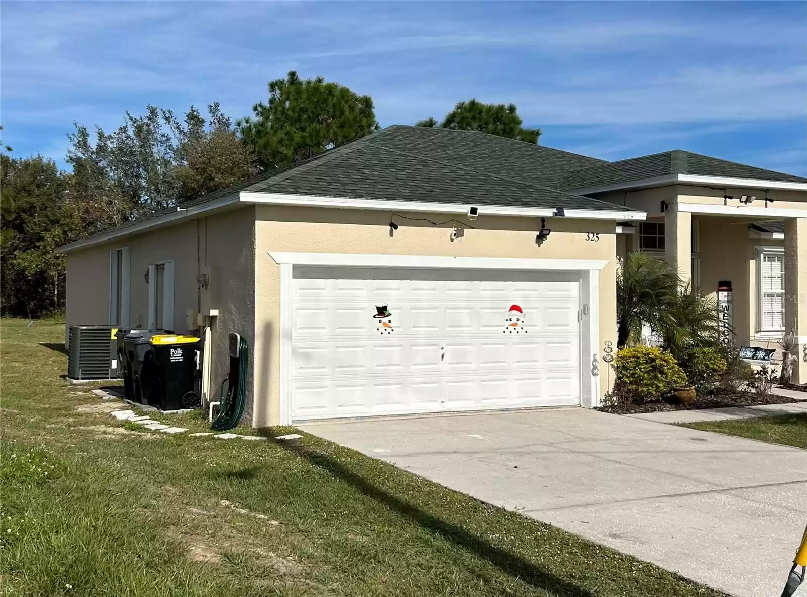 LEFT SIDE FRONT SHUTTERS ON WINDOW AND SIDE GARAGE DOOR, NEW A/C UNIT AND TRASH BINS