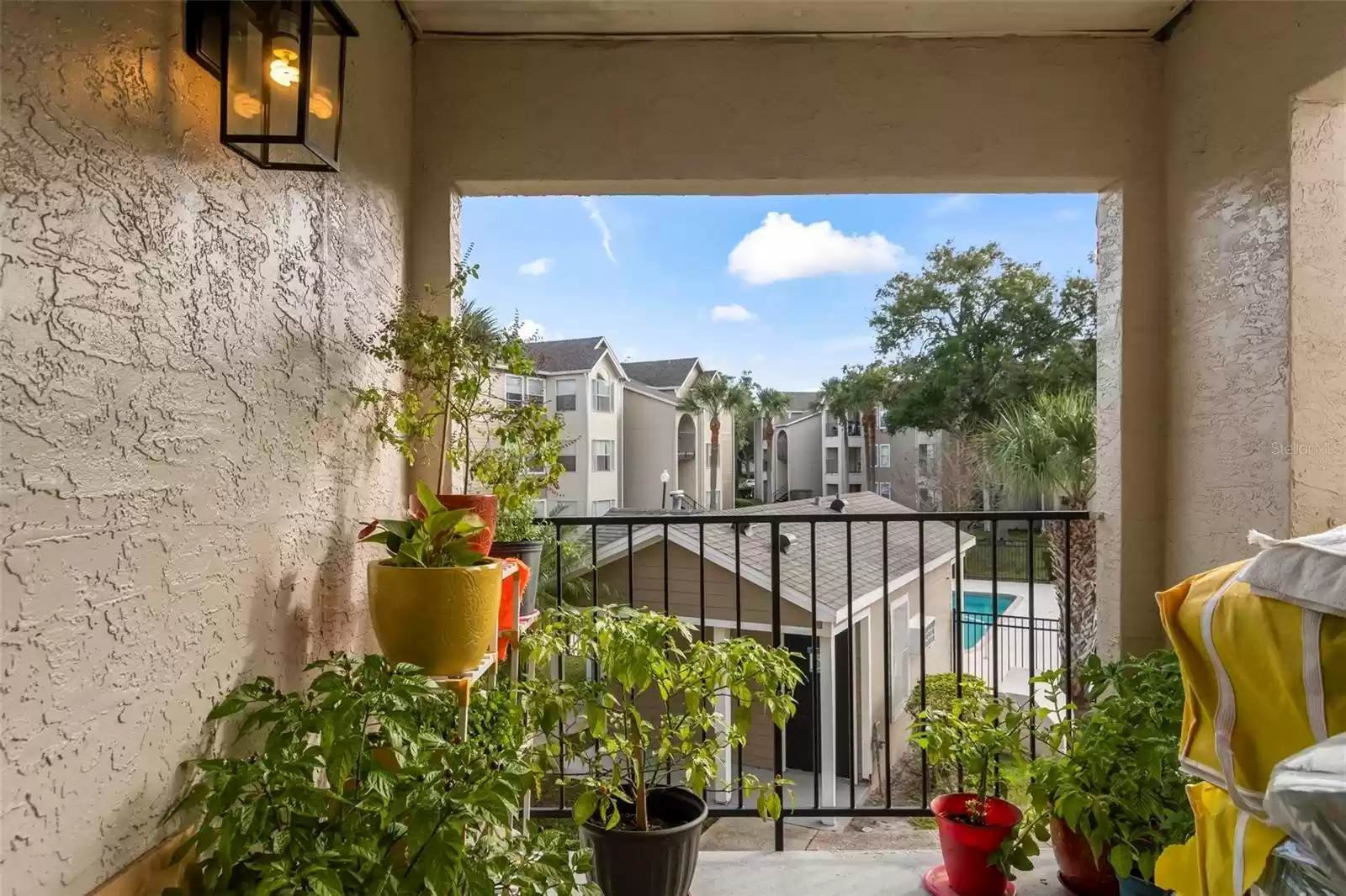 Covered Balcony Overlooking One of the Community Pools and Tennis Courts Providing a Great Place to Relax and Unwind without Leaving Home