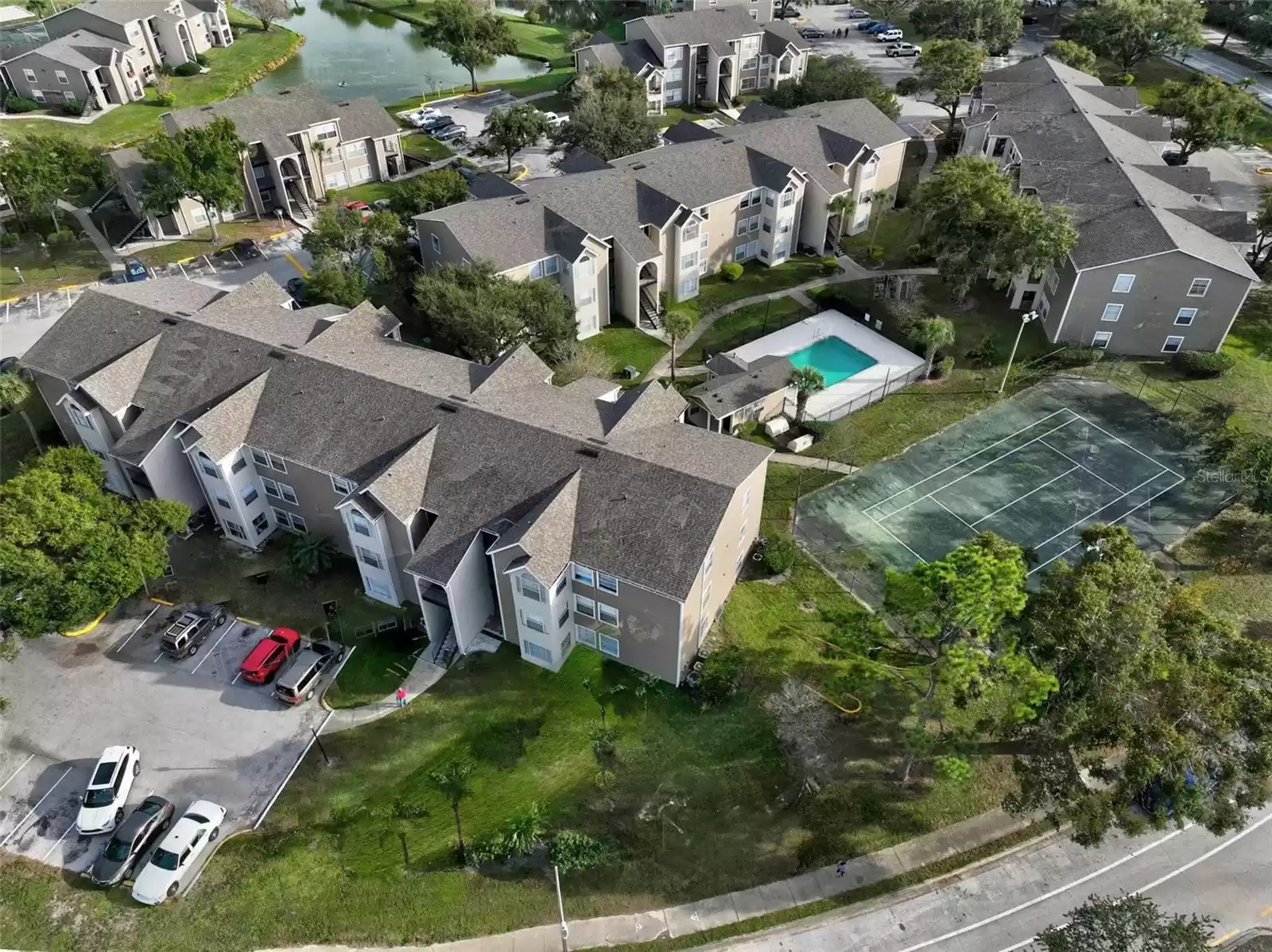 Aerial View of Walden Palms Community with Building 14 in Foreground Overlooking One of the Community Pools and Tennis Court