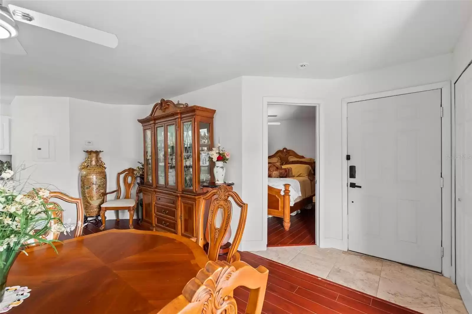 Tiled Foyer with Adjacent Master Suite Pictured to the Left and Utility Room to the Right