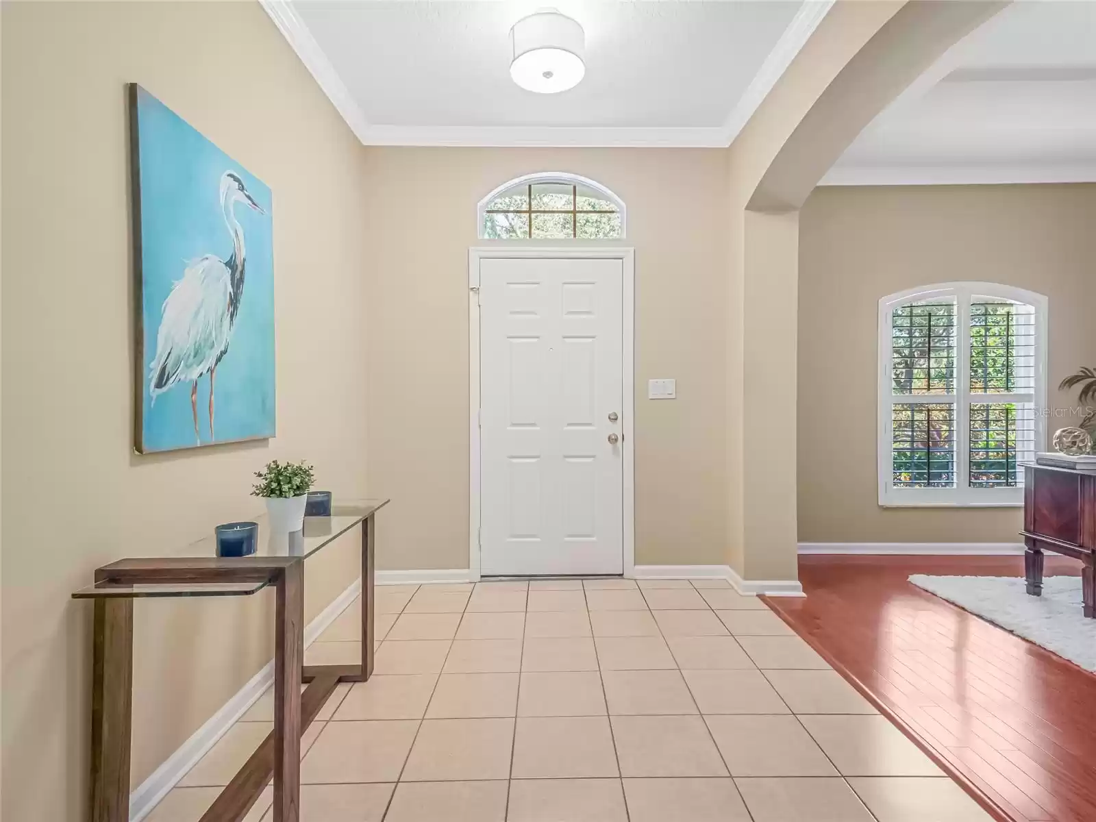 Foyer entryway w/ arched opening to Den/Office