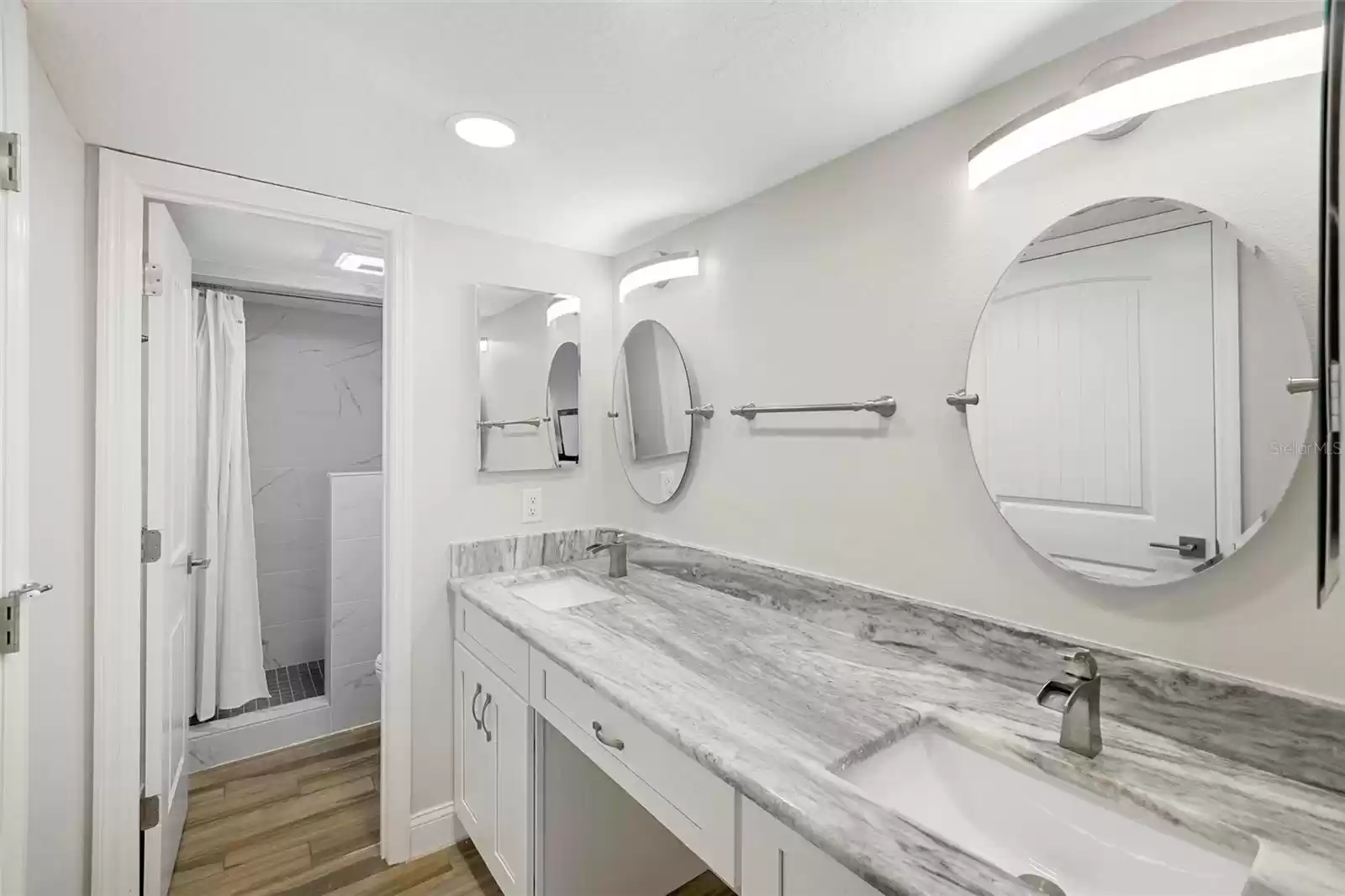 Primary bathroom suite with double sink and granite