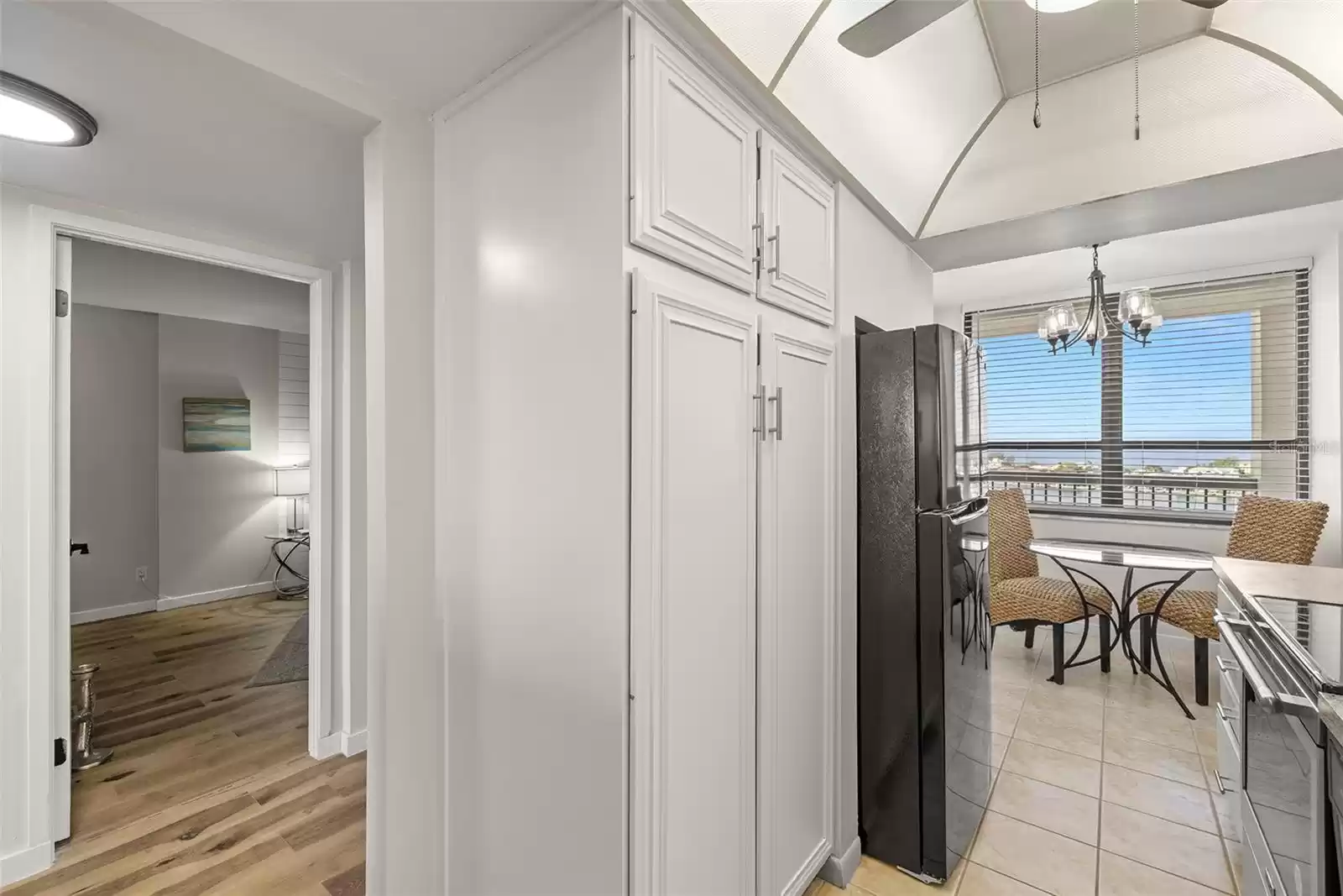 Kitchen features a pantry and eating space by the window