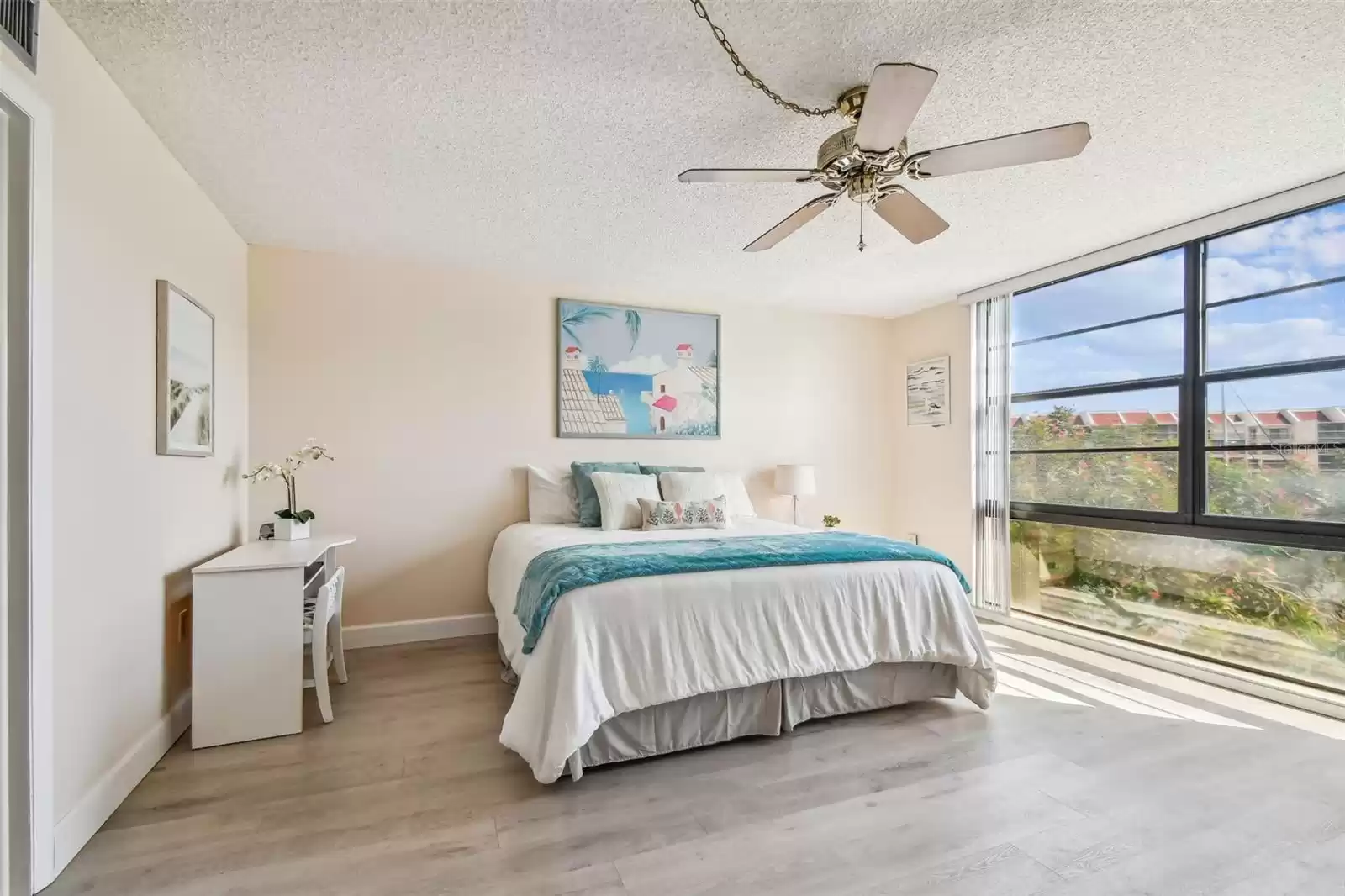 Spacious primary bedroom suite overlooking the water