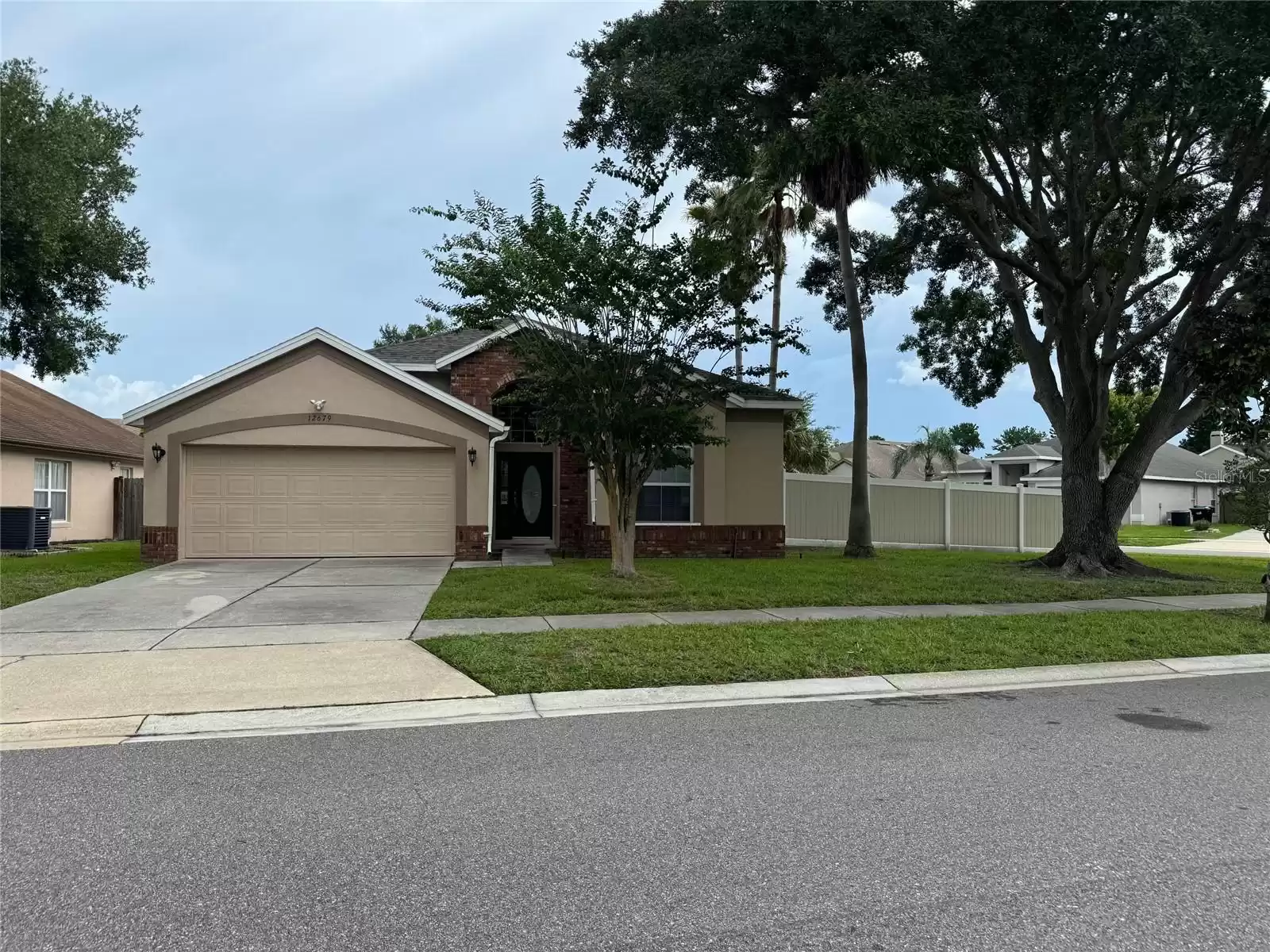 Property street view- Long drive way. with view of beautiful glass entry door.