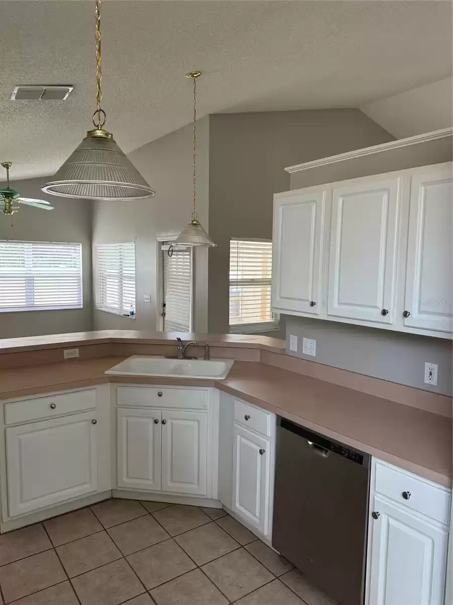 Kitchen view toward Bar and family rm area. Centrally located, where all seem to gather and communicate!