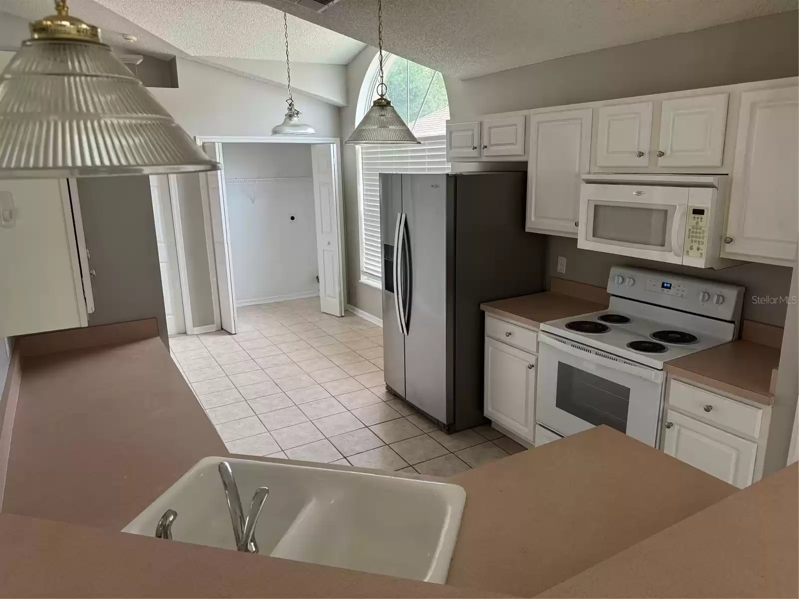 Kitchen view  - Appliance package of Refrigerator, Range, Microwave and Disposal and Dishwasher is included.  Updated Sink and Faucet too.