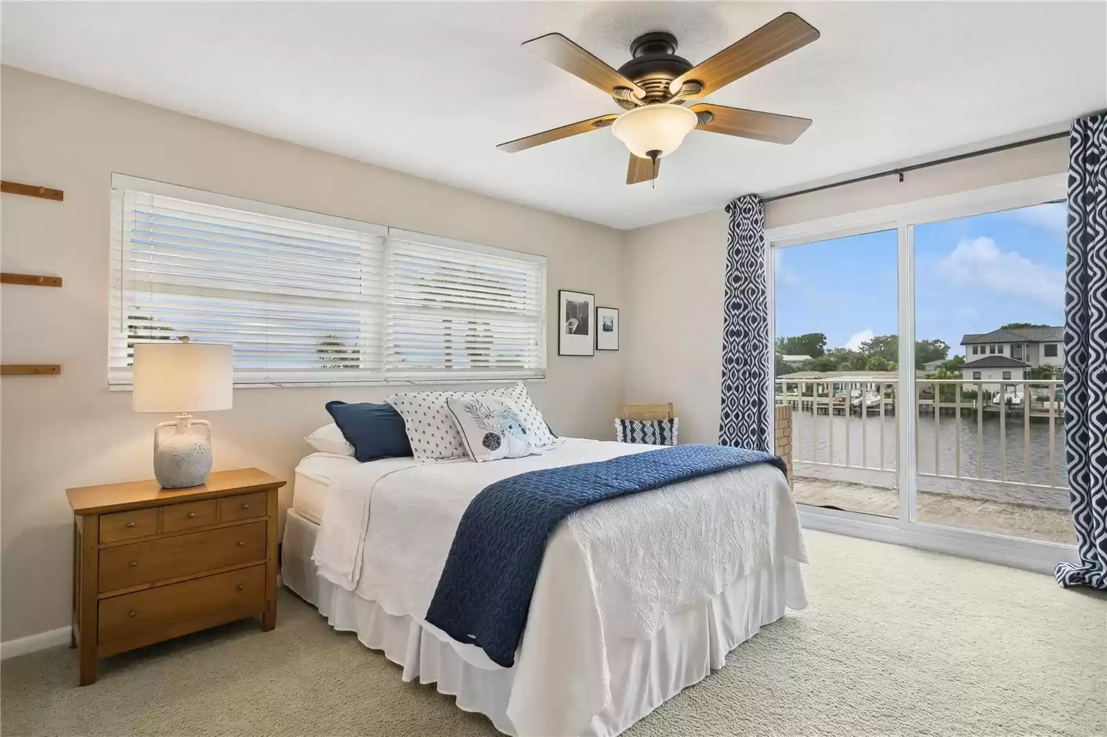 Bedroom 3 with view of water and patio