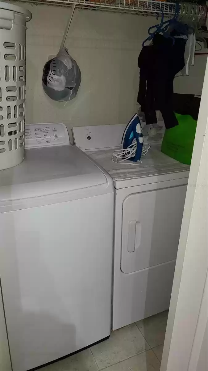 Washer and dryer inside closet.