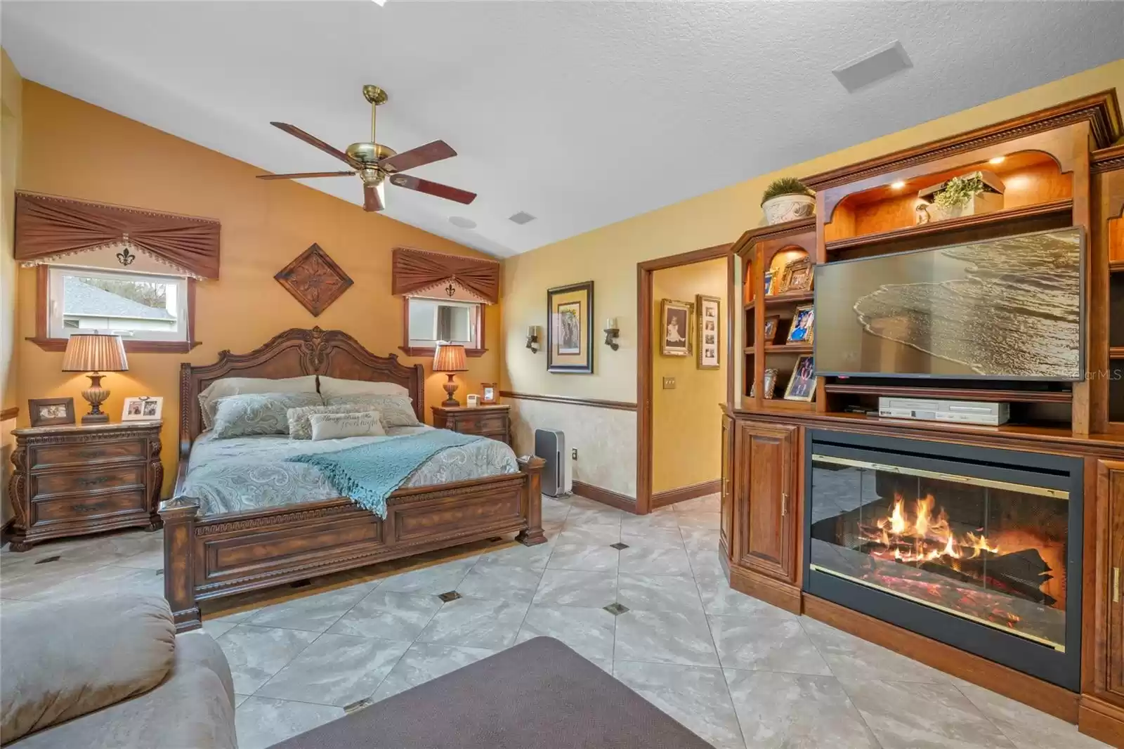 Primary Bedroom with Custom Entertainment Center and Electric Fireplace