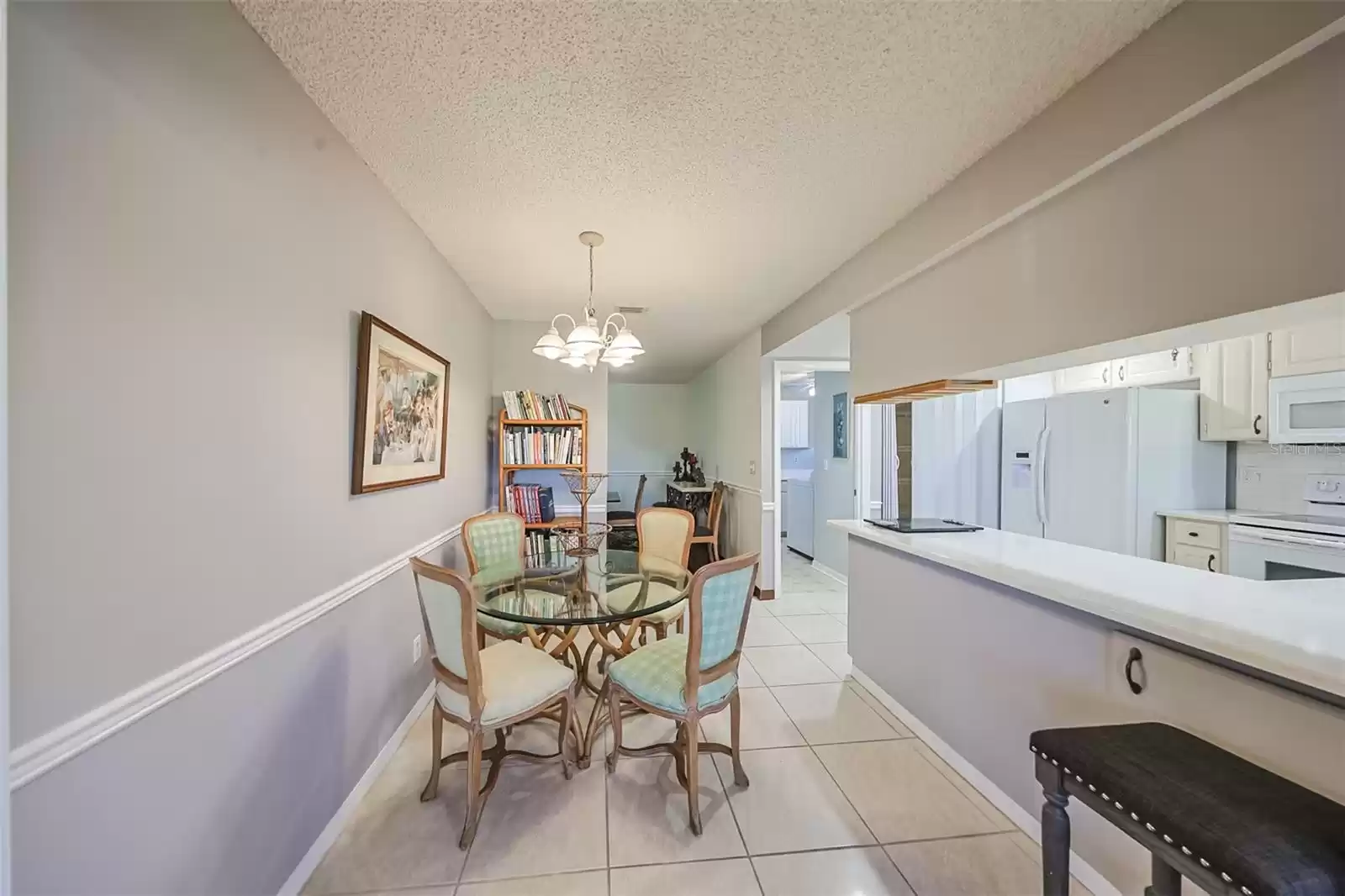 Eat-in dining area overlooks the kitchen with a breakfast bar right next to it, in case you need more seating.