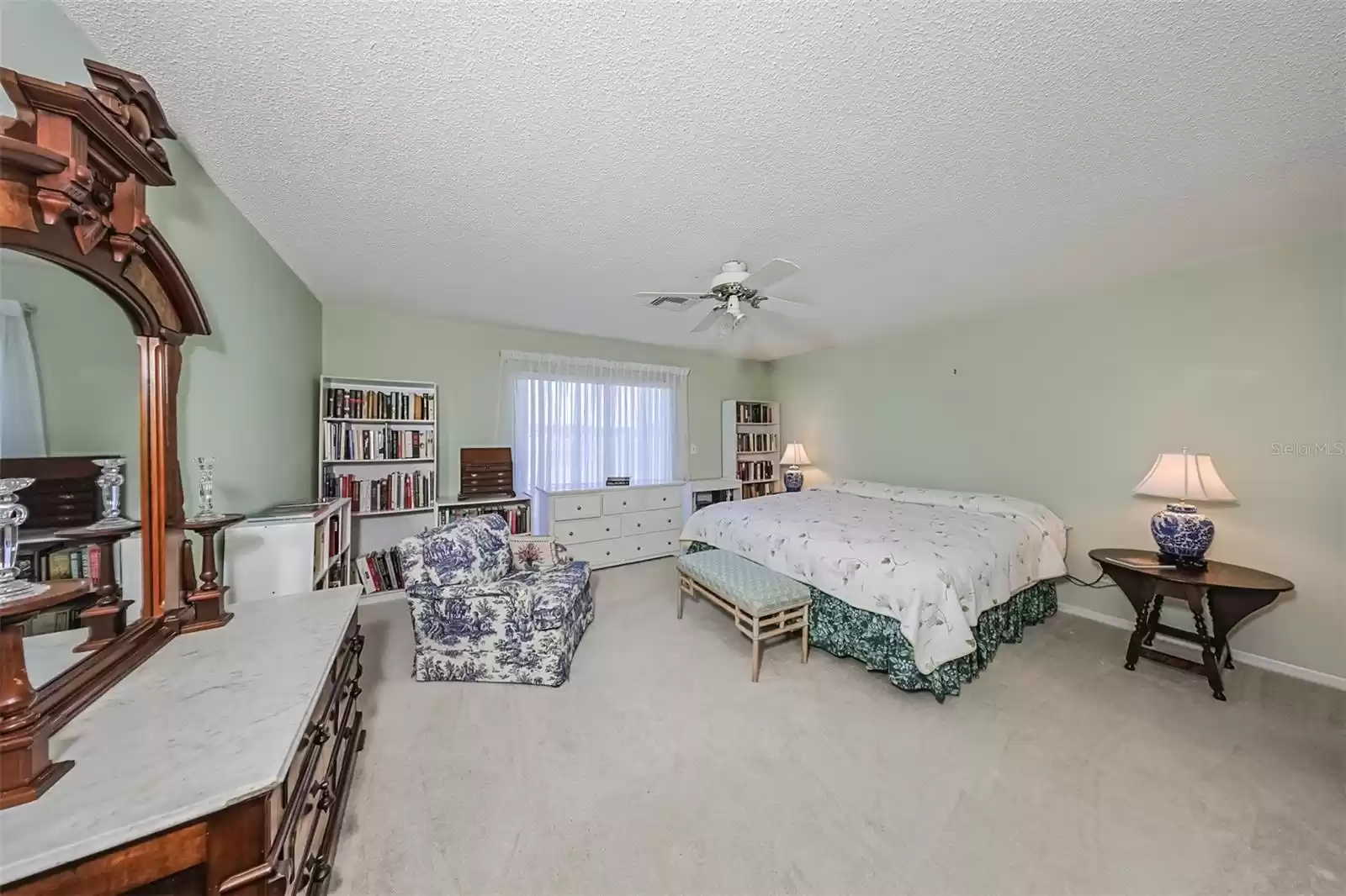 This room is HUGE, bright and  has relaxing paint tones with a view of the green belt.