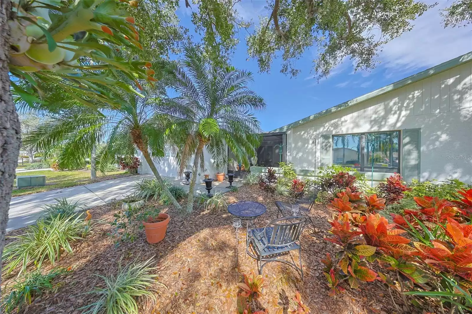 Enjoy sitting in this quaint shaded garden area that has been built in the front yard, as you walk up to the front entrance of the home.