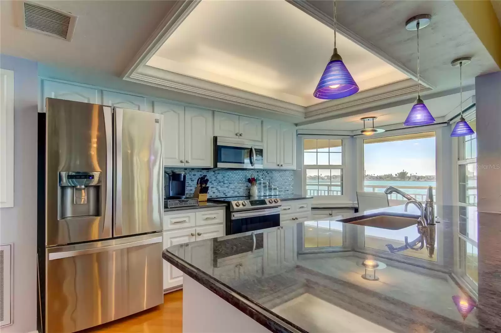 Open concept kitchen with granite counters and stainless appliances