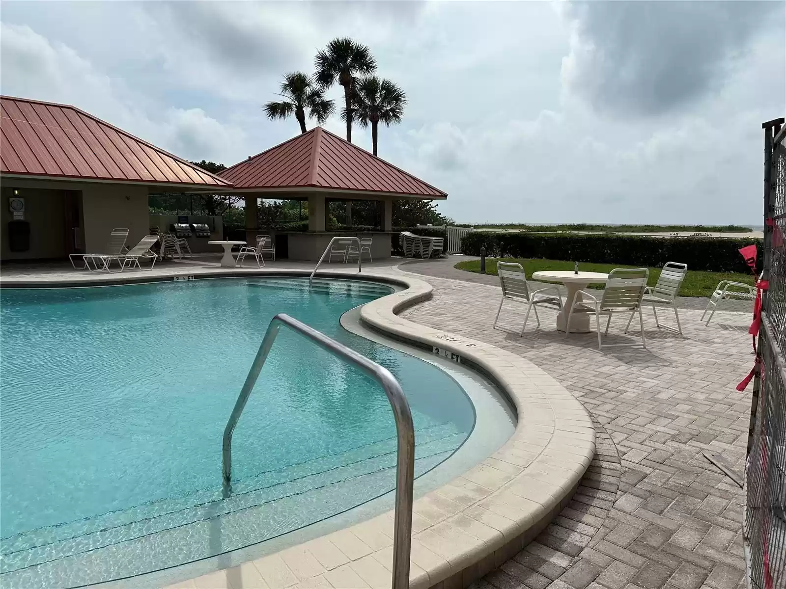 Poolside gazebo with BBQ grills, bar + baths