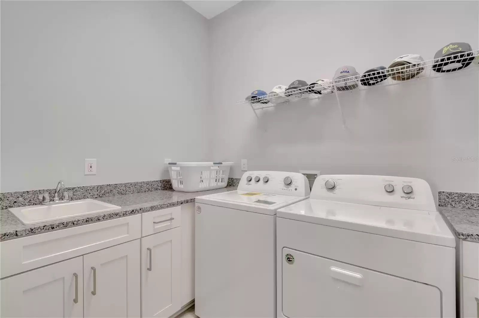 Laundry room upgraded with cabinets and sink