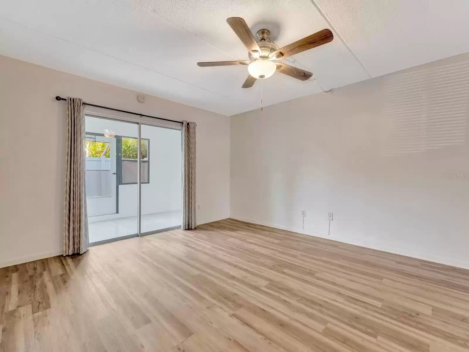 The living room with sliding doors opening to the Florida room