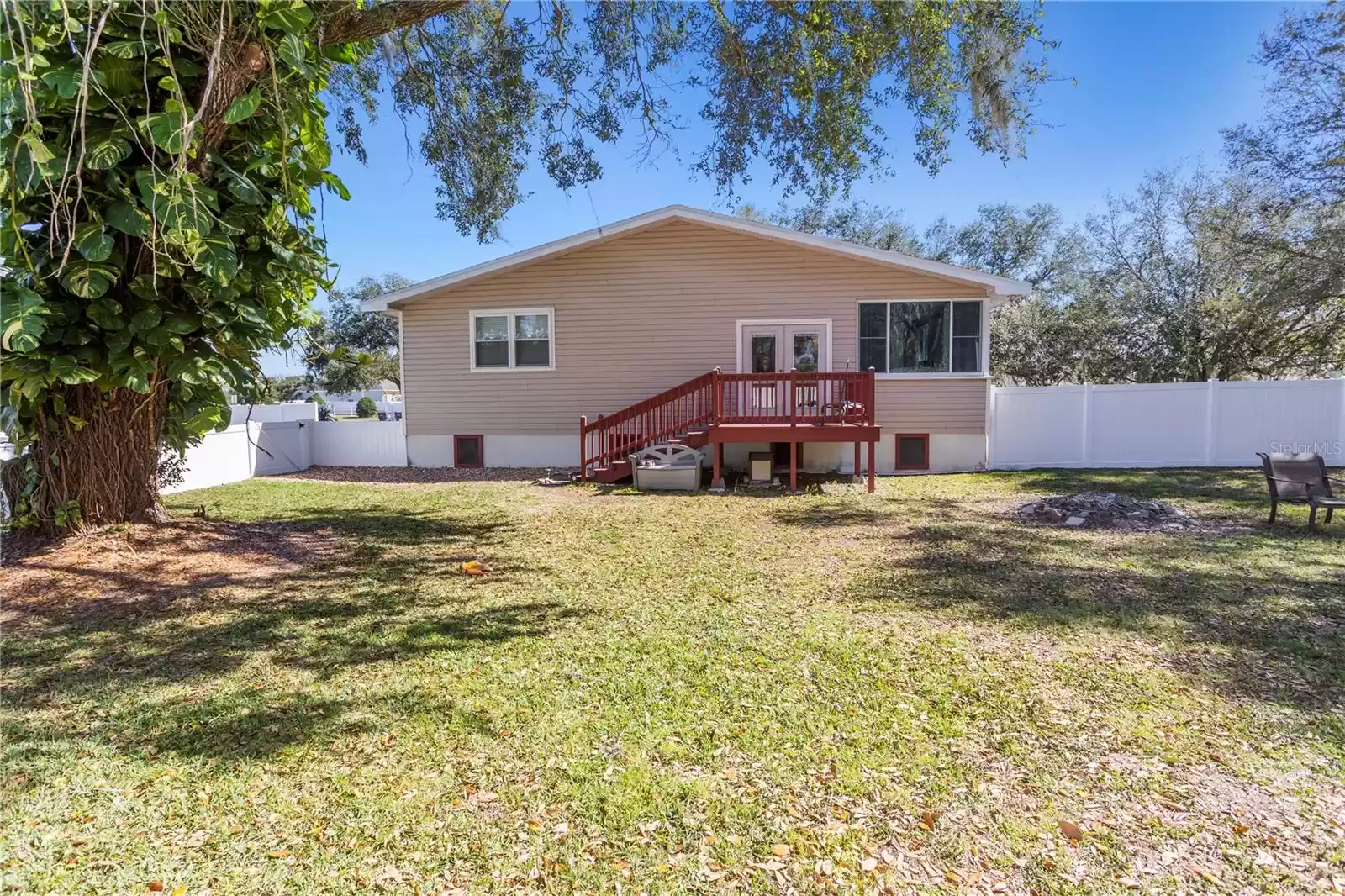 fenced backyard with large deck