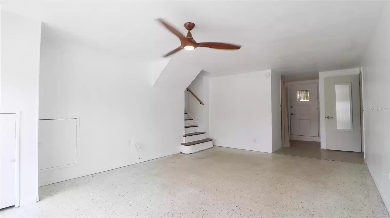 Downstairs  multi-use space. Perfect space for a pool table! Laundry room located towards back.