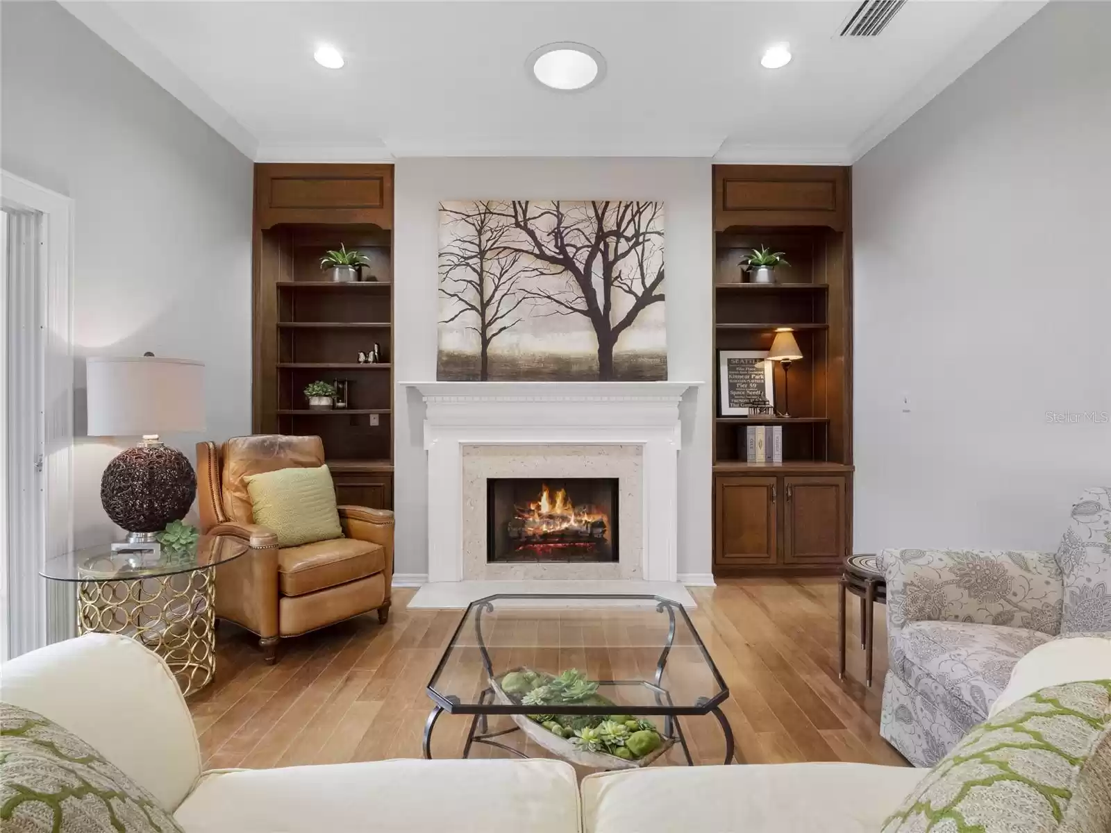 Family room with wood floors, built-ins, and crown molding