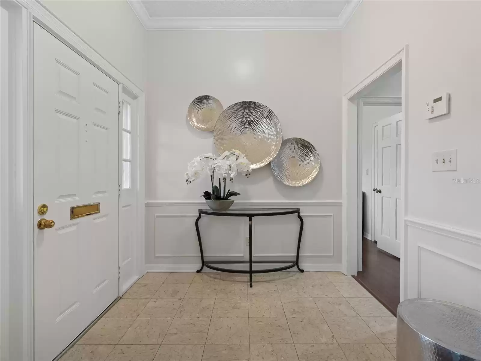 Foyer with wainscoting and crown molding