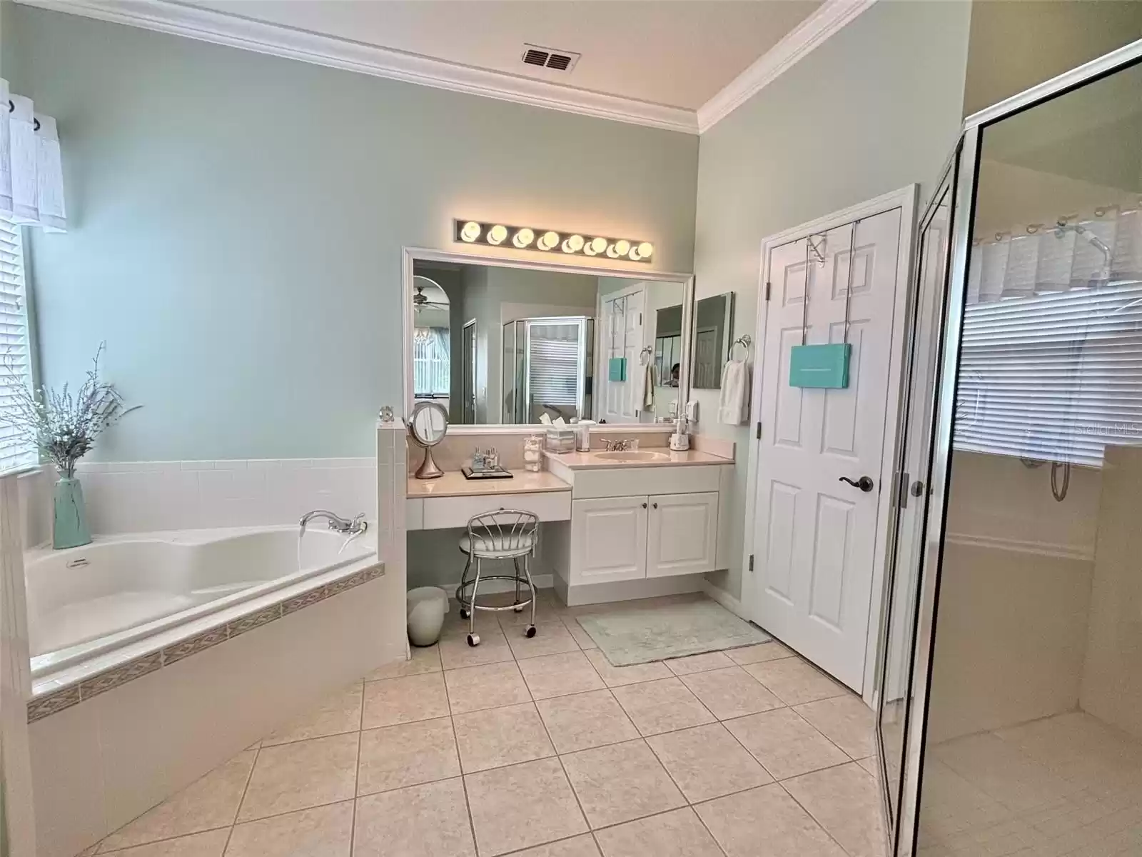 Primary bathroom- split vanities with built in dressing table. Separate garden tub