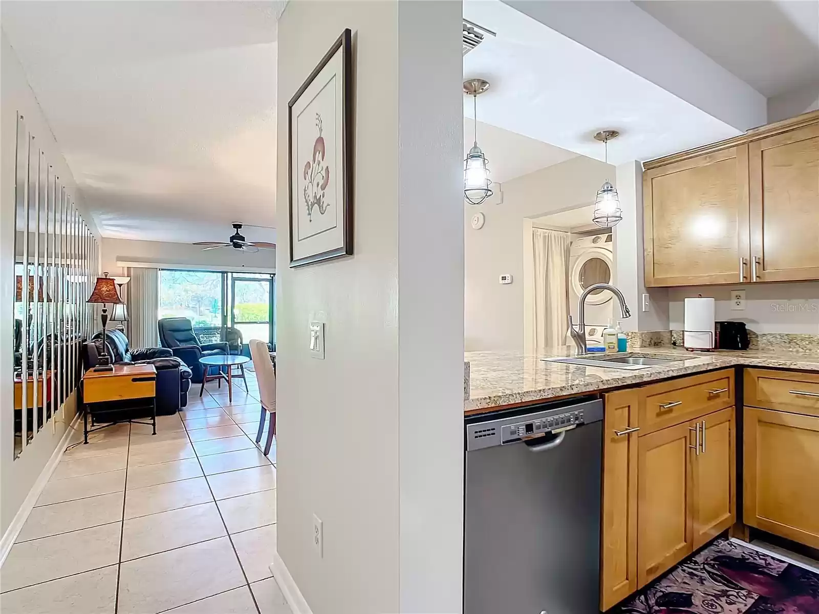 Entry foyer leading living room and dining room with kitchen on the right.