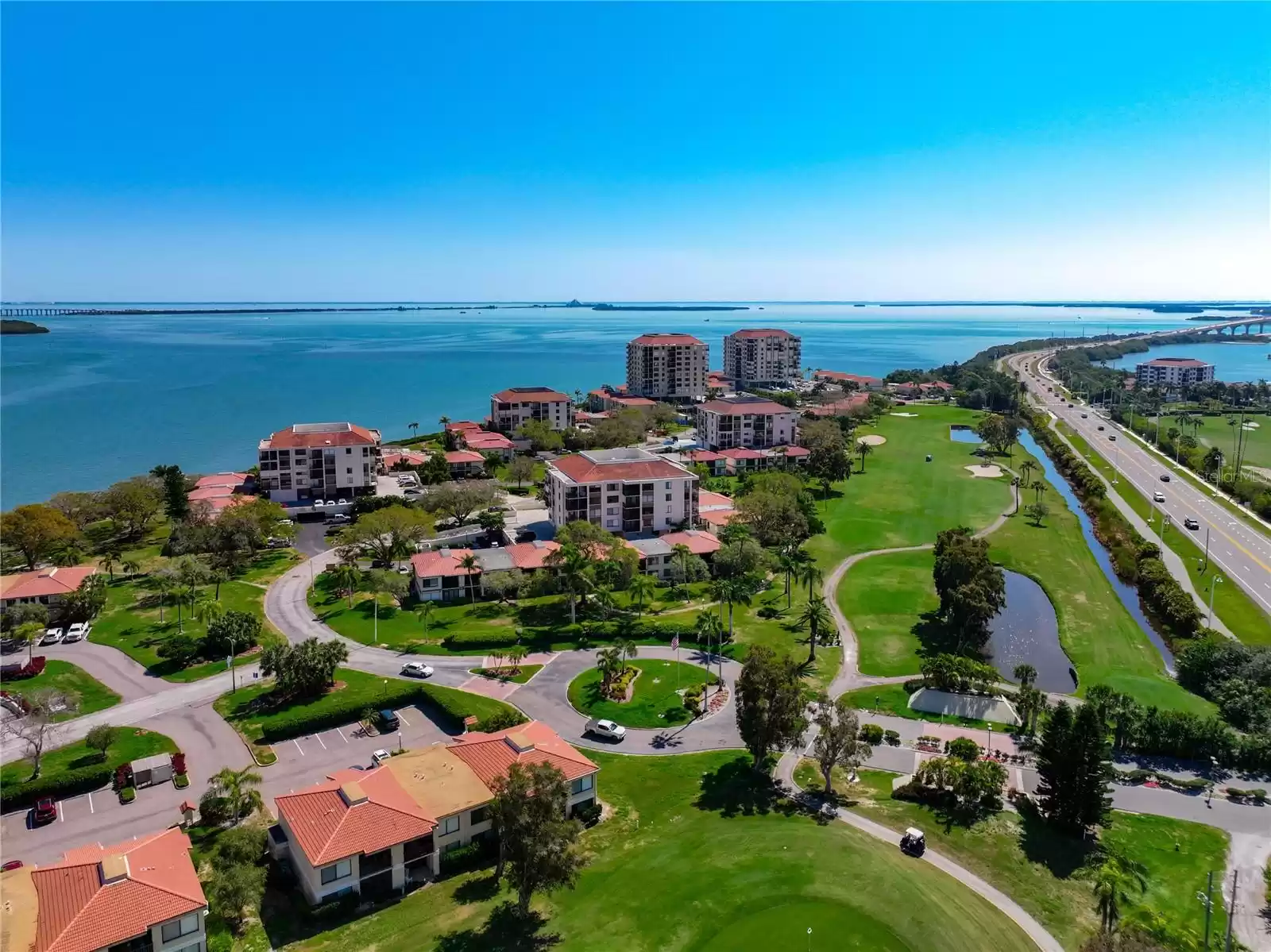 Aerial to southeast across Tampa Bay. Pinellas Bayway to Tierra Verde is on the right.