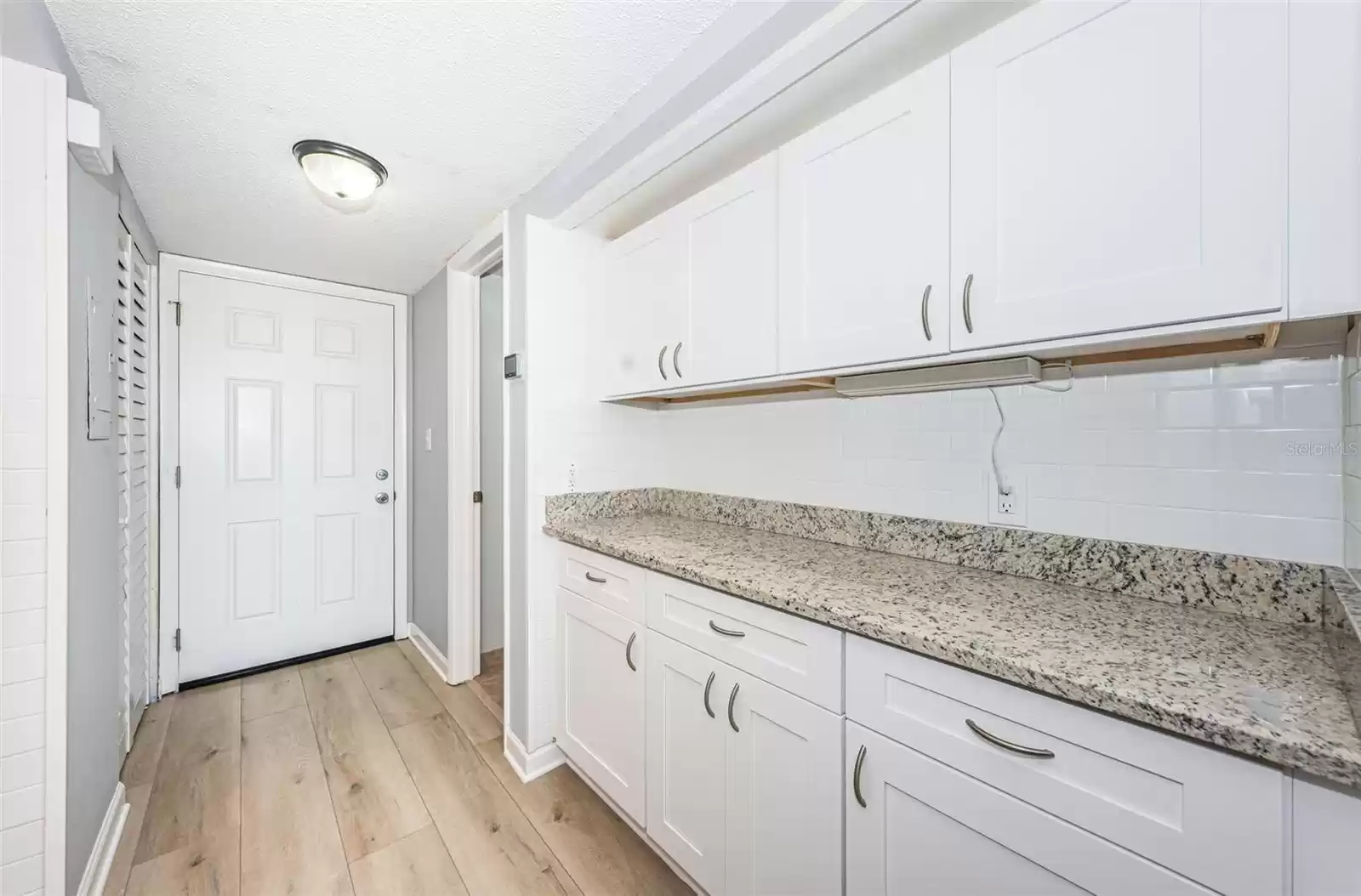 Utility Closet to left of front door- New HVAC, New louvered bifold door, New shelving for storage