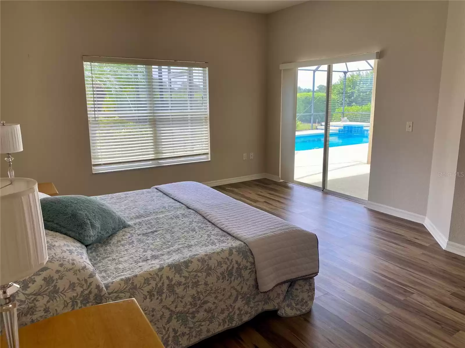 Master bedroom with sliding doors to pool and lanai