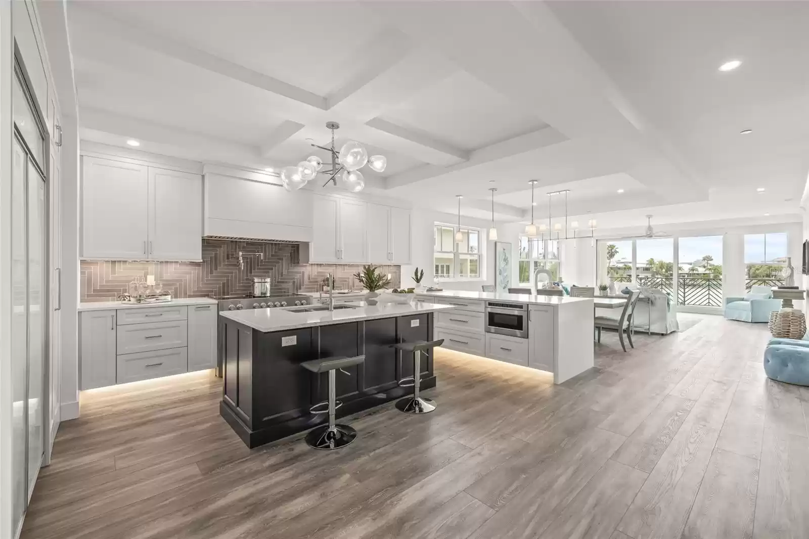 The kitchen overlooks the dining/living room and out to the balcony overlooking the water