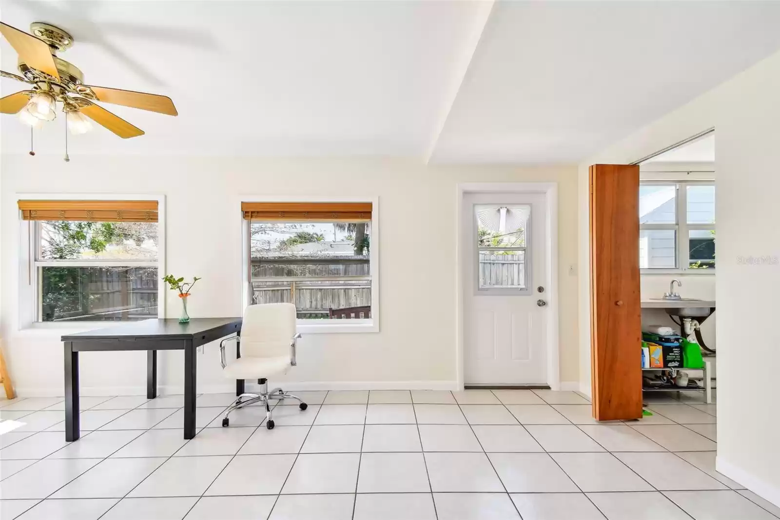 A large Florida room envelops guests in airy comfort, with expansive windows overlooking lush tropical foliage and providing a sun-drenched sanctuary for relaxation and leisurely gatherings.