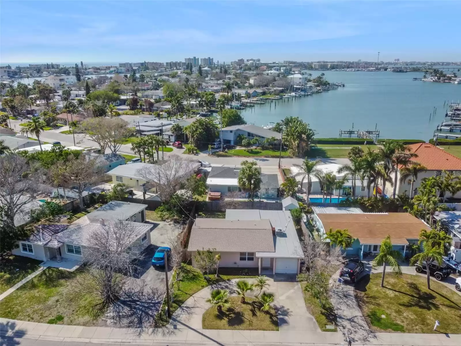 This home is completely enveloped by breathtaking expanses of shimmering water, offering a serene retreat where the soothing rhythm of the waves serenades the soul.