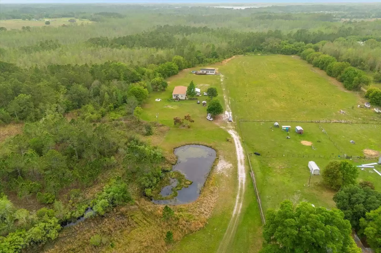 property overview with the pond, main home in the front