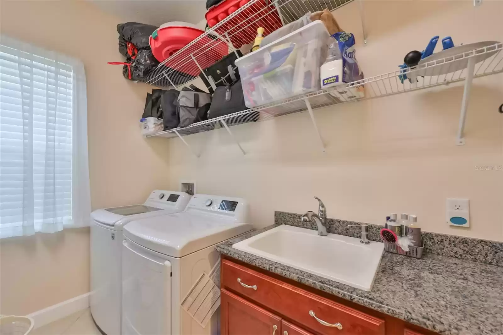 Laundry Room is indoors and perfect for year round weather concerns. Complete with storage, sink with granite countertop and cabinets. Washer and Dryer included.