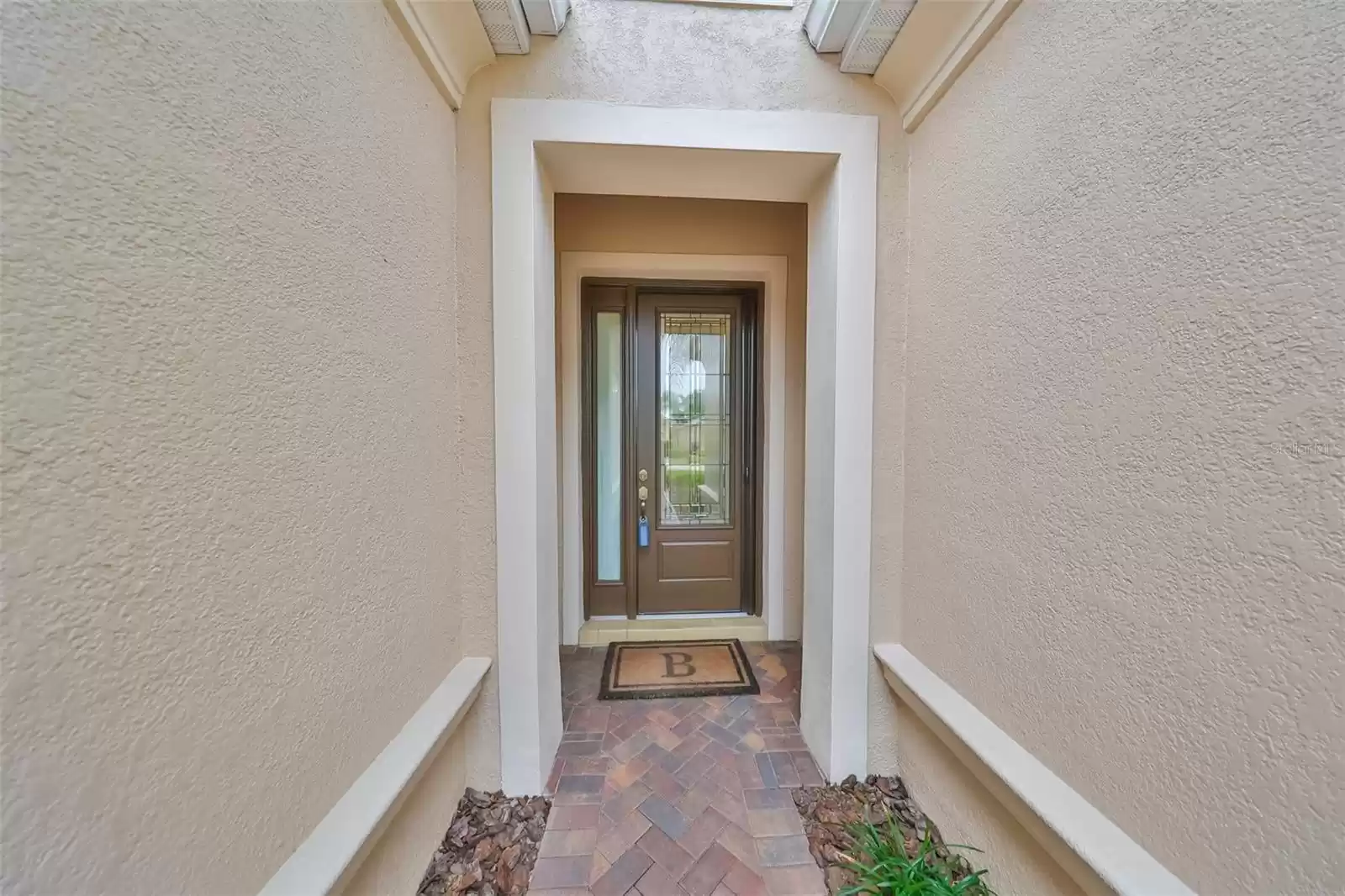 The lead-glass door entrance to this luxury home is beautifully manicured and well maintained. Walking to the front door or up and down the street, you immediately feel the 