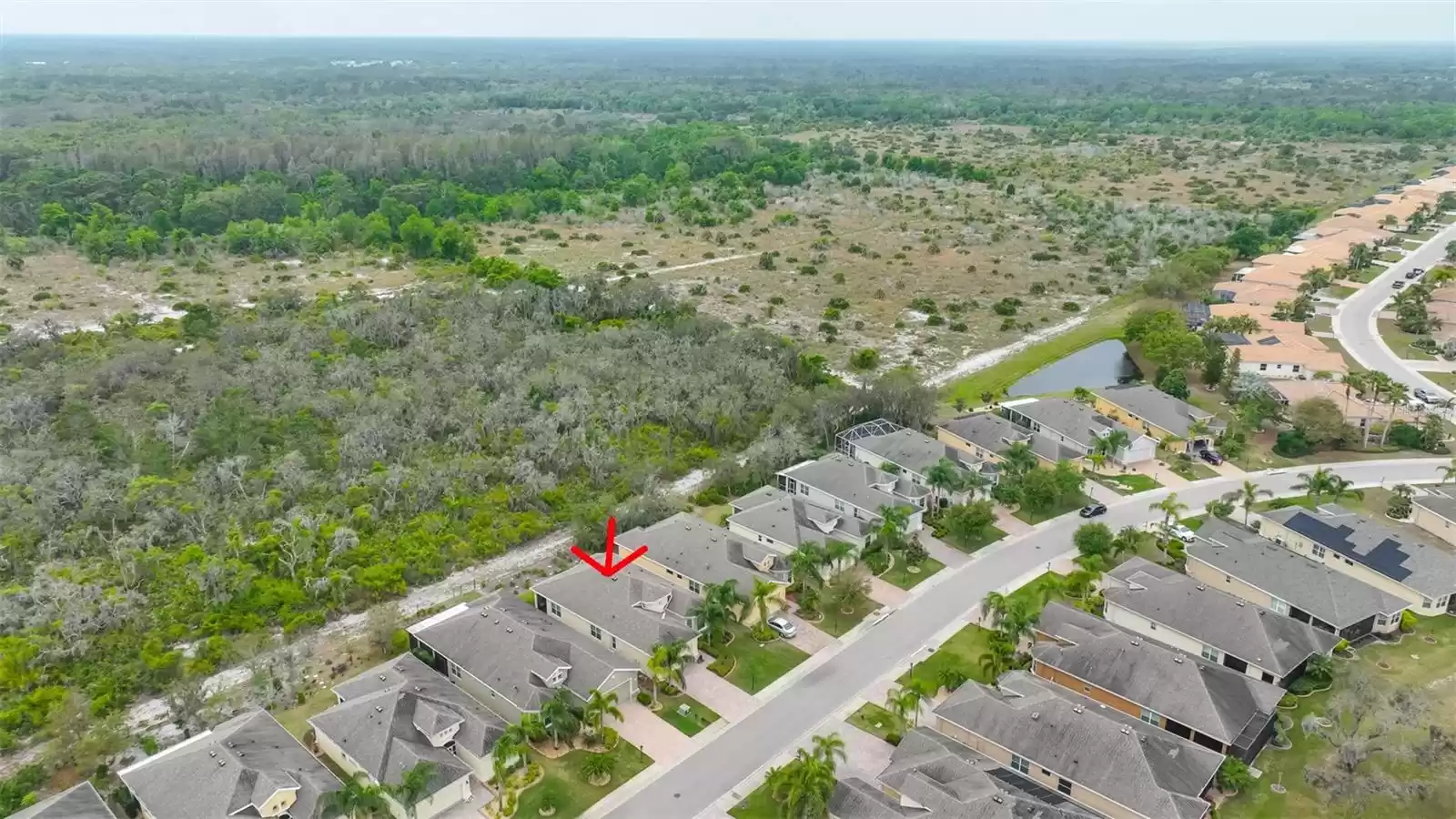 Ariel view of community, with home outlined in red arrow.