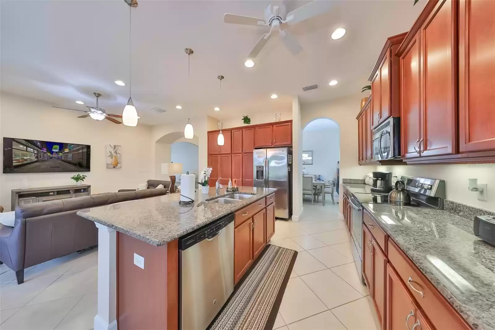 The abundant kitchen cabinets are a handsome red oak color, with pull out drawers, granite counters and under cabinet lighting.  So much storage space and a large pantry closet. Notice the 10' ceilings with recessed lights.