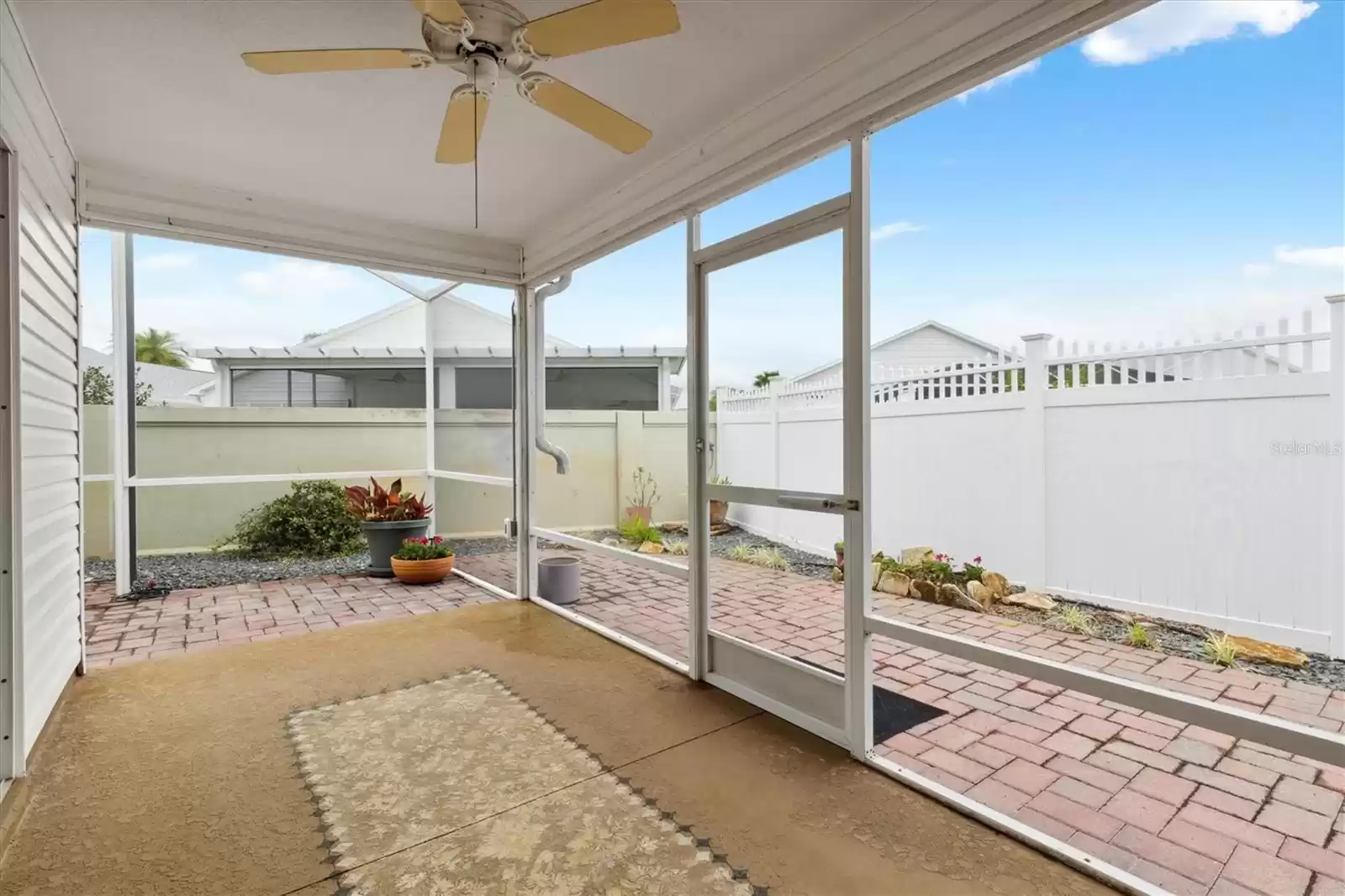 SCREENED LANAI OVERLOOKING PAVER OUTDOOR SPACE  NO GRASS